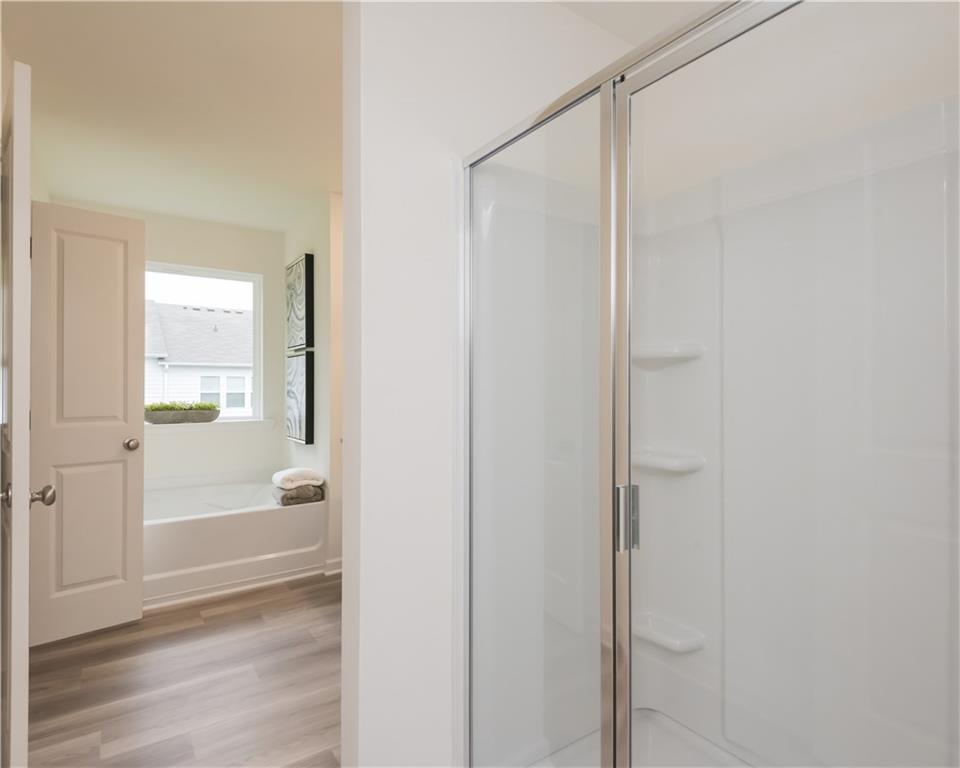 1819 Dawn Road, Unit 16 Conyers, GA 30013 - Photo 28 of 28 a view of a bathroom with a glass shower door
