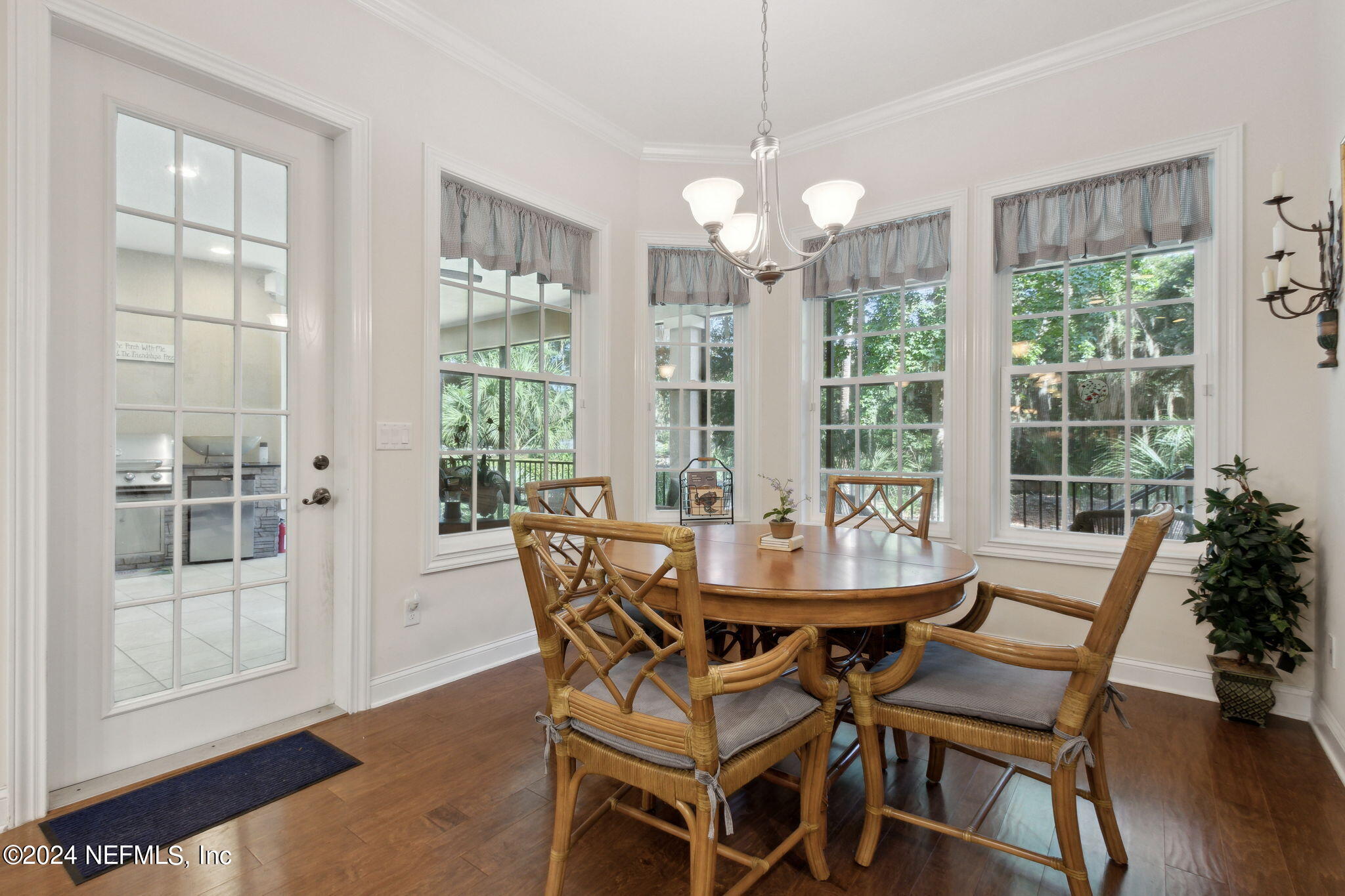 5 Sea Marsh Road Fernandina Beach, FL 32034 - Photo 23 of 71 a dining room with furniture wooden floor and a chandelier