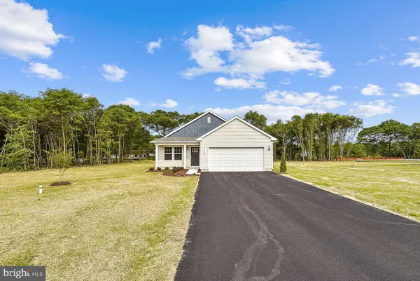 a view of a house with a yard and large trees