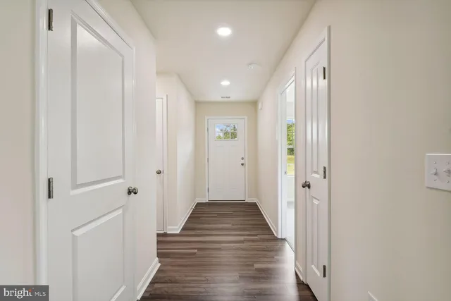 a view of a hallway with wooden floor