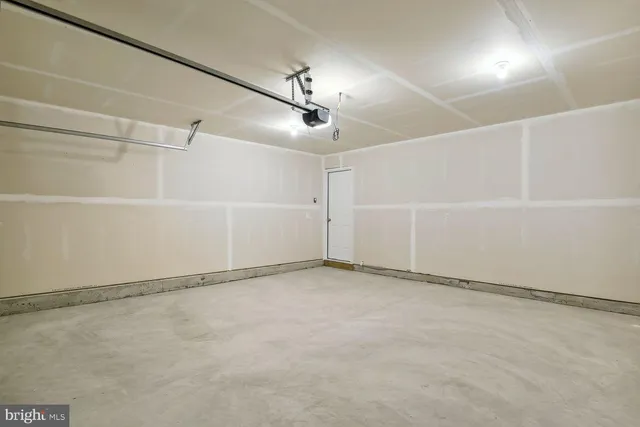 a kitchen with a refrigerator a sink and cabinets