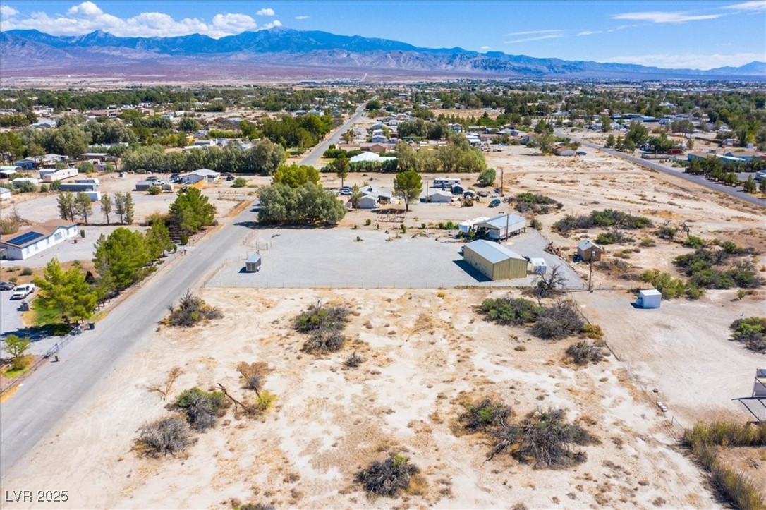 1921 West Dyer Road Pahrump, NV 89048 - Photo 13 of 28 Aerial view of sparsely populated area featuring a desert landscape and a mountainous background