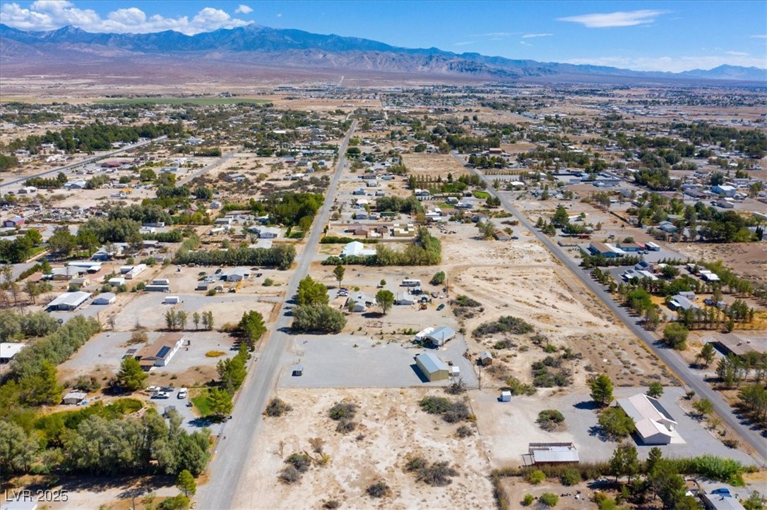 1921 West Dyer Road Pahrump, NV 89048 - Photo 21 of 28 Drone / aerial view of a mountain backdrop and a desert landscape