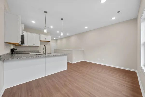 a large kitchen with kitchen island a sink stainless steel appliances and cabinets