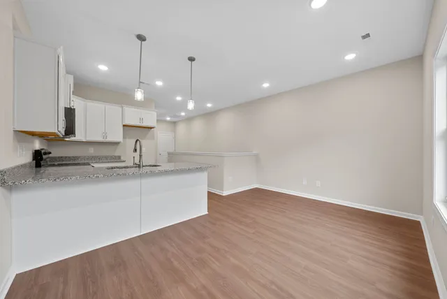 a large kitchen with kitchen island a sink stainless steel appliances and cabinets