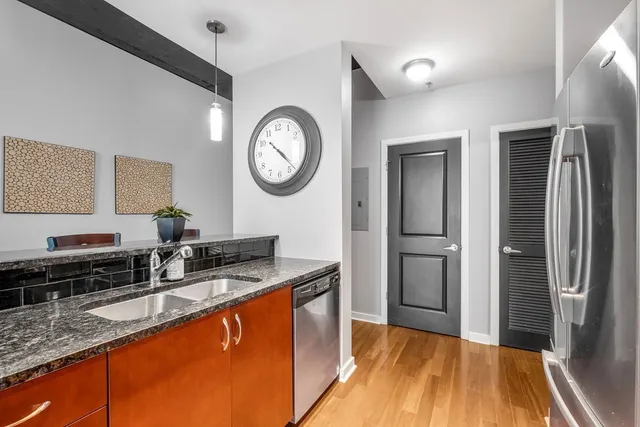 a kitchen with lots of counter top space and wooden floor