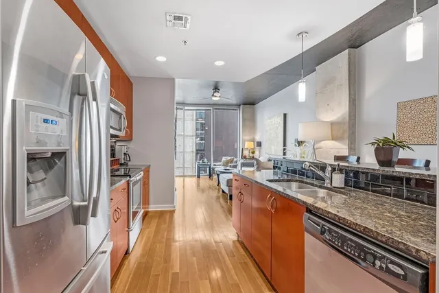 a kitchen with stainless steel appliances granite countertop a stove and a microwave