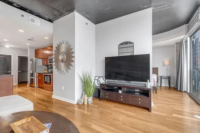 a large bed sitting in a bedroom next to a window