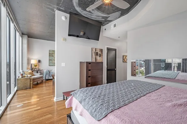 a bedroom with a bed and a chandelier