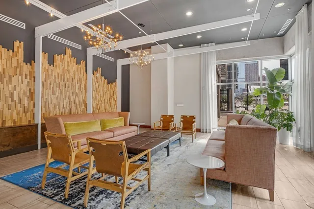 a large bed sitting in a bedroom next to a window