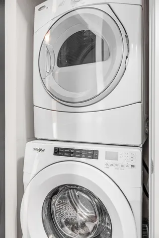 a bathroom with a granite countertop sink toilet mirror and bathtub
