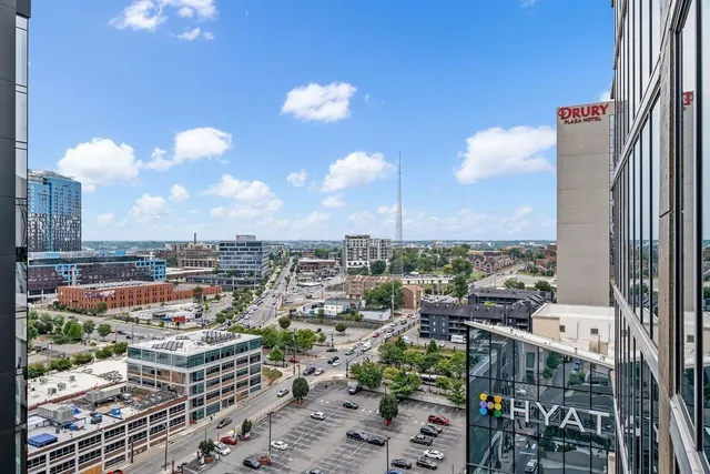a kitchen with a dining table chairs and white cabinets