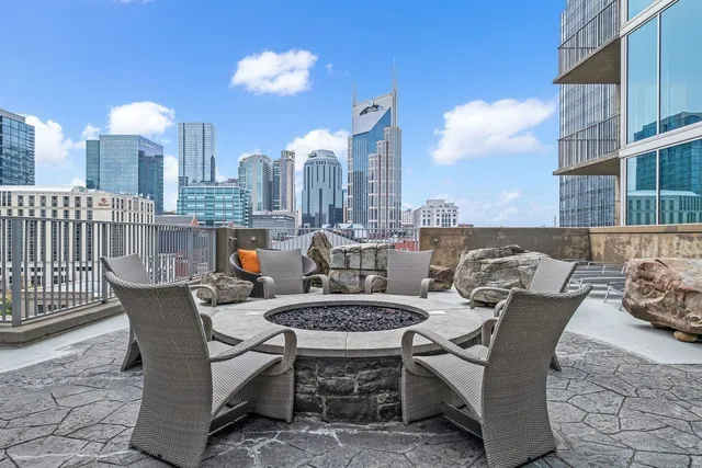a swimming pool with outdoor seating and city view