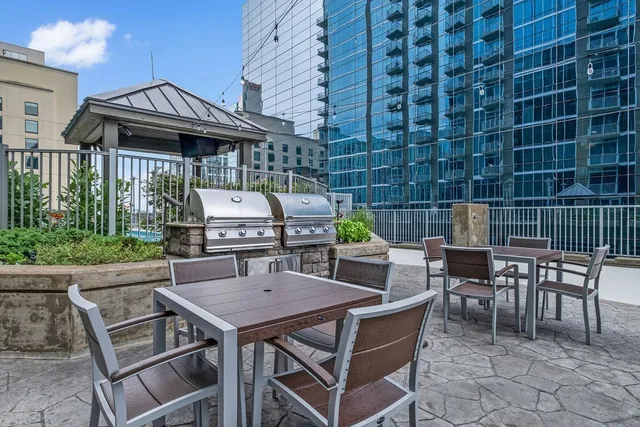 a view of a patio filled with furniture and plants