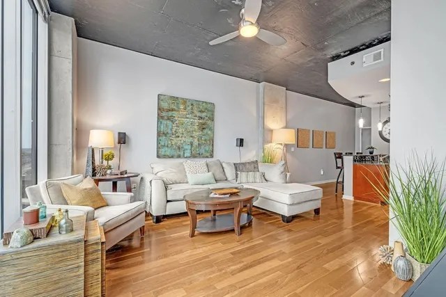 a living room with furniture and a wooden floor