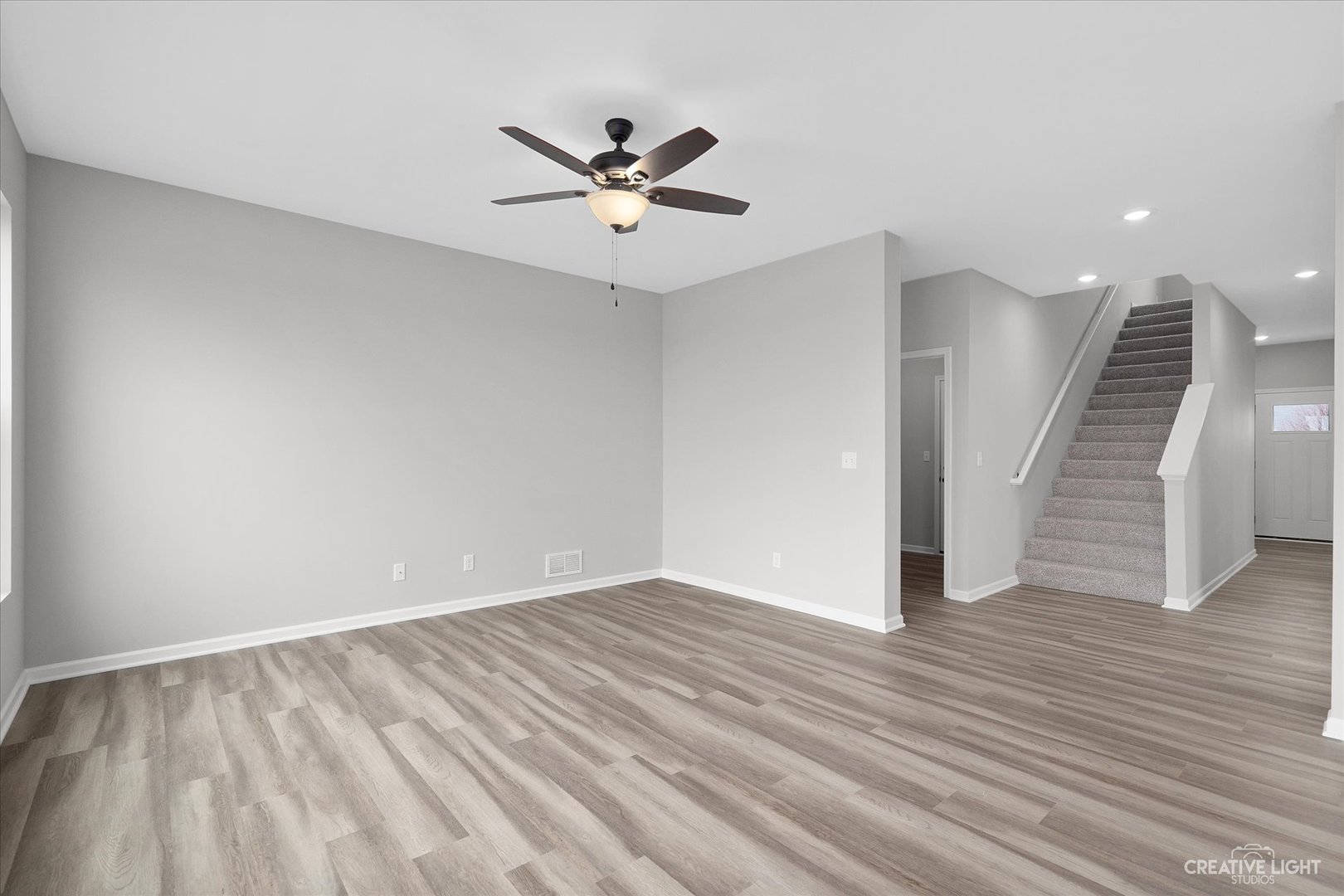 501 Hahn Drive Cortland, IL 60112 - Photo 11 of 27 a view of an empty room with wooden floor and a ceiling fan