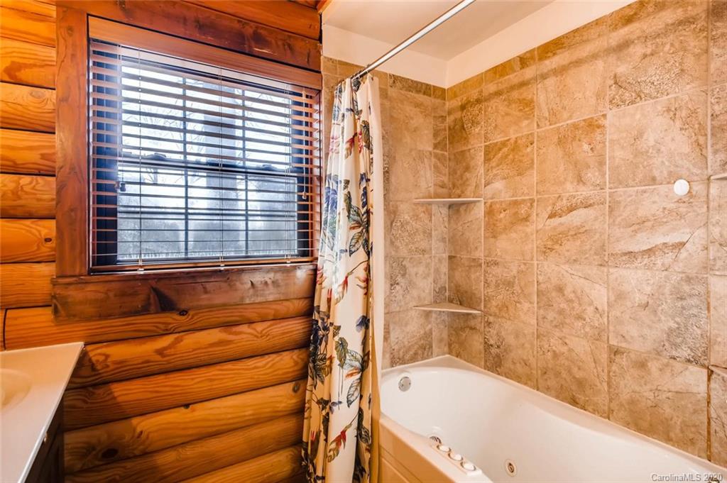 4323 Hubbard Road Charlotte, NC 28269 - Photo 13 of 35 a bathroom with a bathtub and a shower