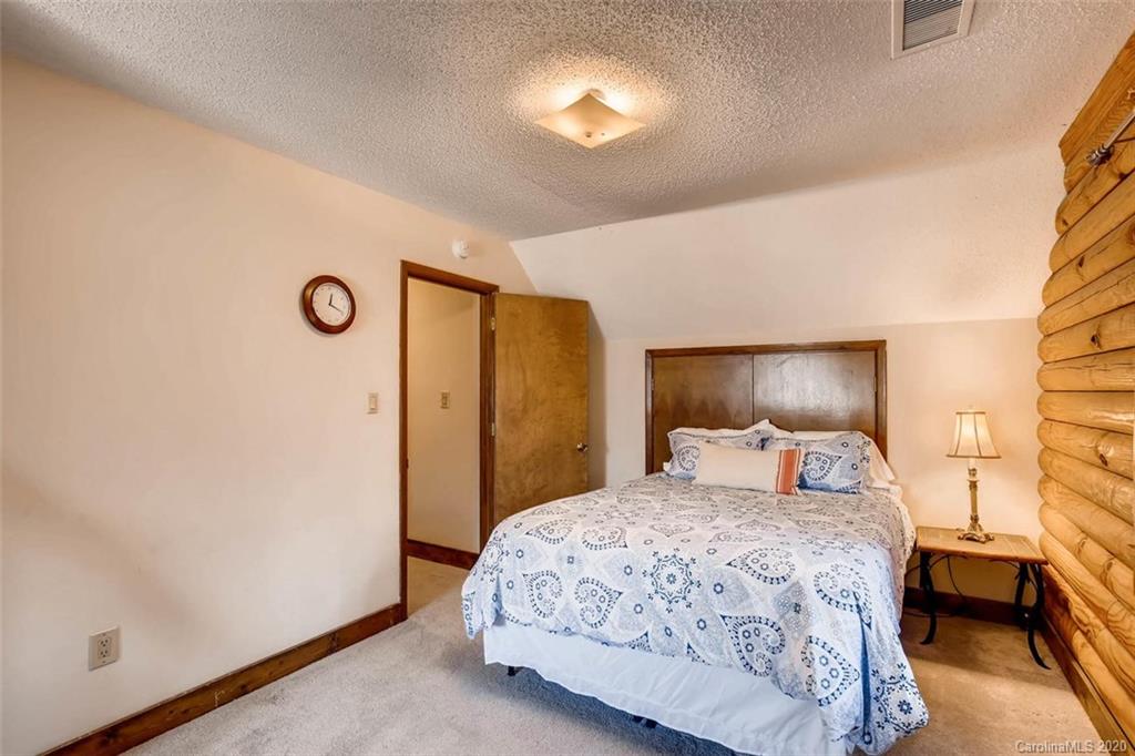 4323 Hubbard Road Charlotte, NC 28269 - Photo 17 of 35 a bedroom with a bed and a lamp with window