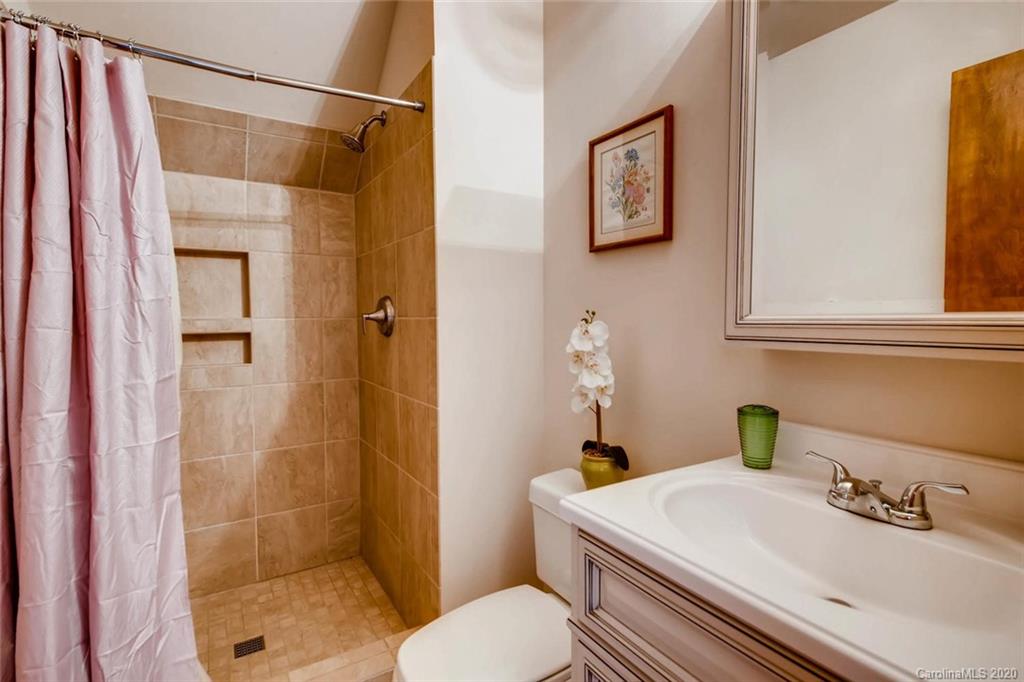 4323 Hubbard Road Charlotte, NC 28269 - Photo 18 of 35 a bathroom with a sink toilet and shower