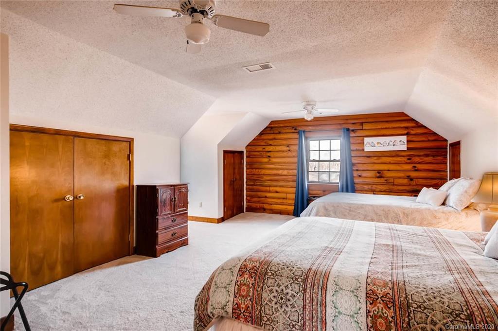 4323 Hubbard Road Charlotte, NC 28269 - Photo 19 of 35 a bedroom with a bed and a chandelier