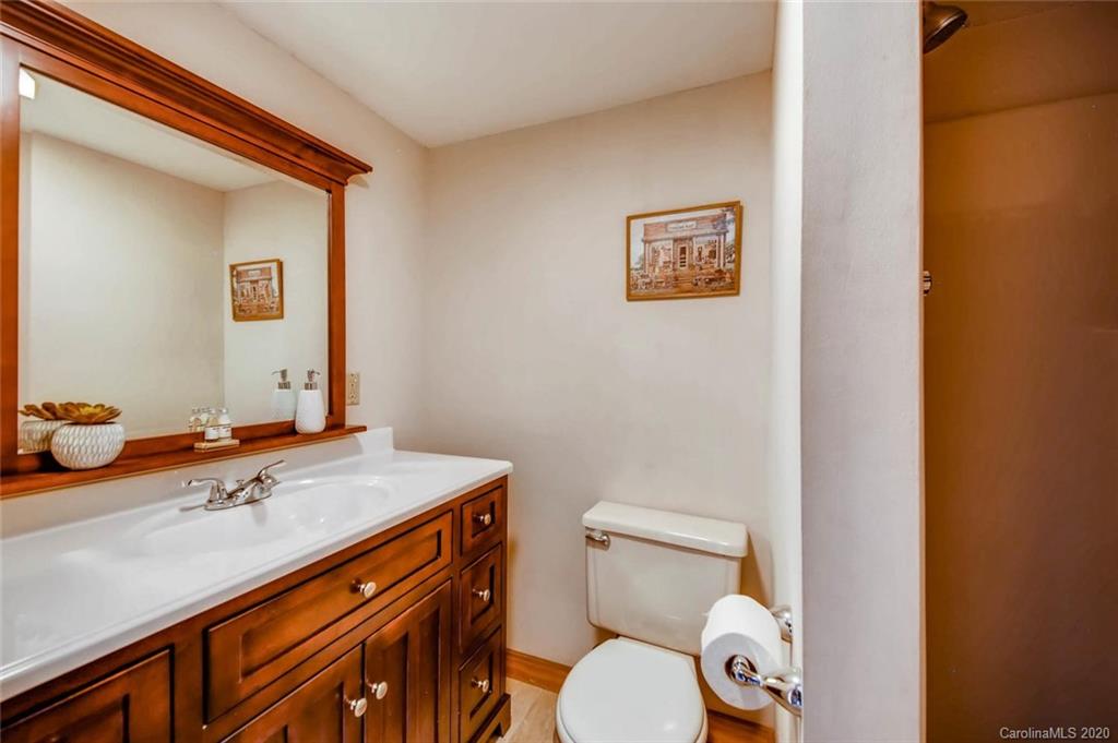 4323 Hubbard Road Charlotte, NC 28269 - Photo 25 of 35 a bathroom with a granite countertop toilet sink and mirror