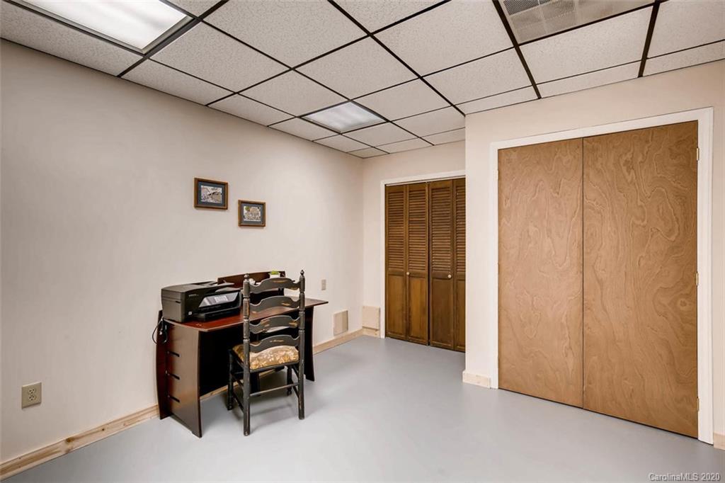 4323 Hubbard Road Charlotte, NC 28269 - Photo 26 of 35 a room that has a bed and a chair in it