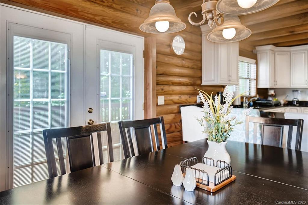 4323 Hubbard Road Charlotte, NC 28269 - Photo 7 of 35 a view of a dining room with furniture a chandelier and wooden floor