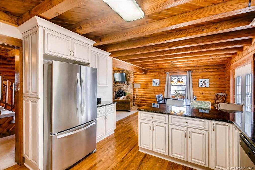 4323 Hubbard Road Charlotte, NC 28269 - Photo 10 of 35 a kitchen with stainless steel appliances a refrigerator and a hard wood floor
