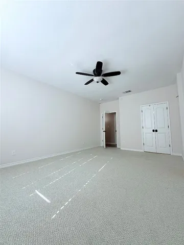 a view of a livingroom with a ceiling fan and window