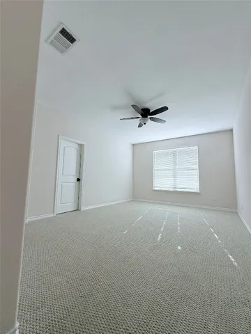 a view of a big room with closet and chandelier fan