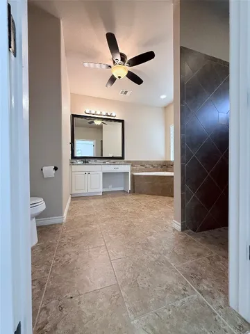 a living room with a large bed and a large mirror