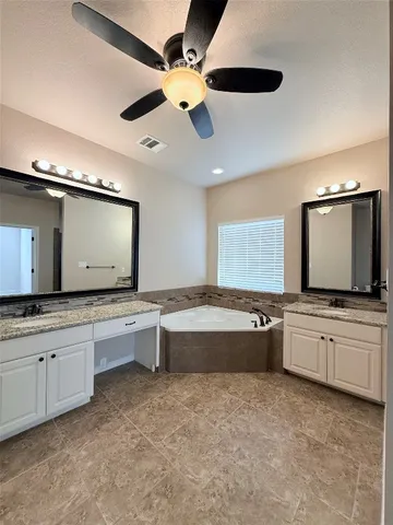 a large kitchen with a large counter space and stainless steel appliances