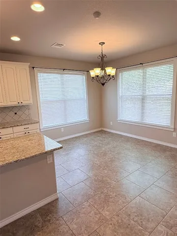 a view of a kitchen with a sink and chandelier