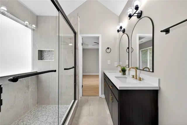 a en suite bathroom with a double vanity sink a and mirror