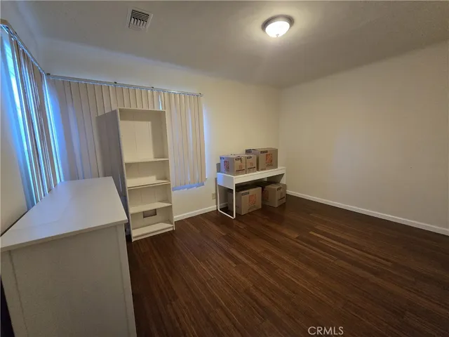 a room with wooden floor and furniture