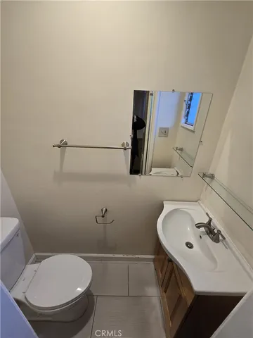 a bathroom with a sink toilet and mirror