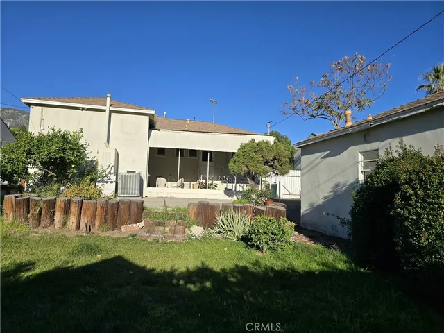 a view of a house with backyard and sitting area