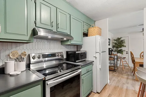 a kitchen with a stove and a refrigerator