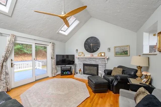 a living room with furniture a fireplace and a flat screen tv
