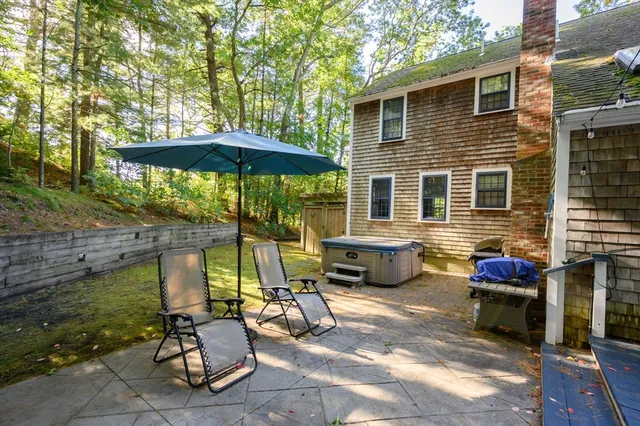 a view of a patio with a table and chairs under an umbrella