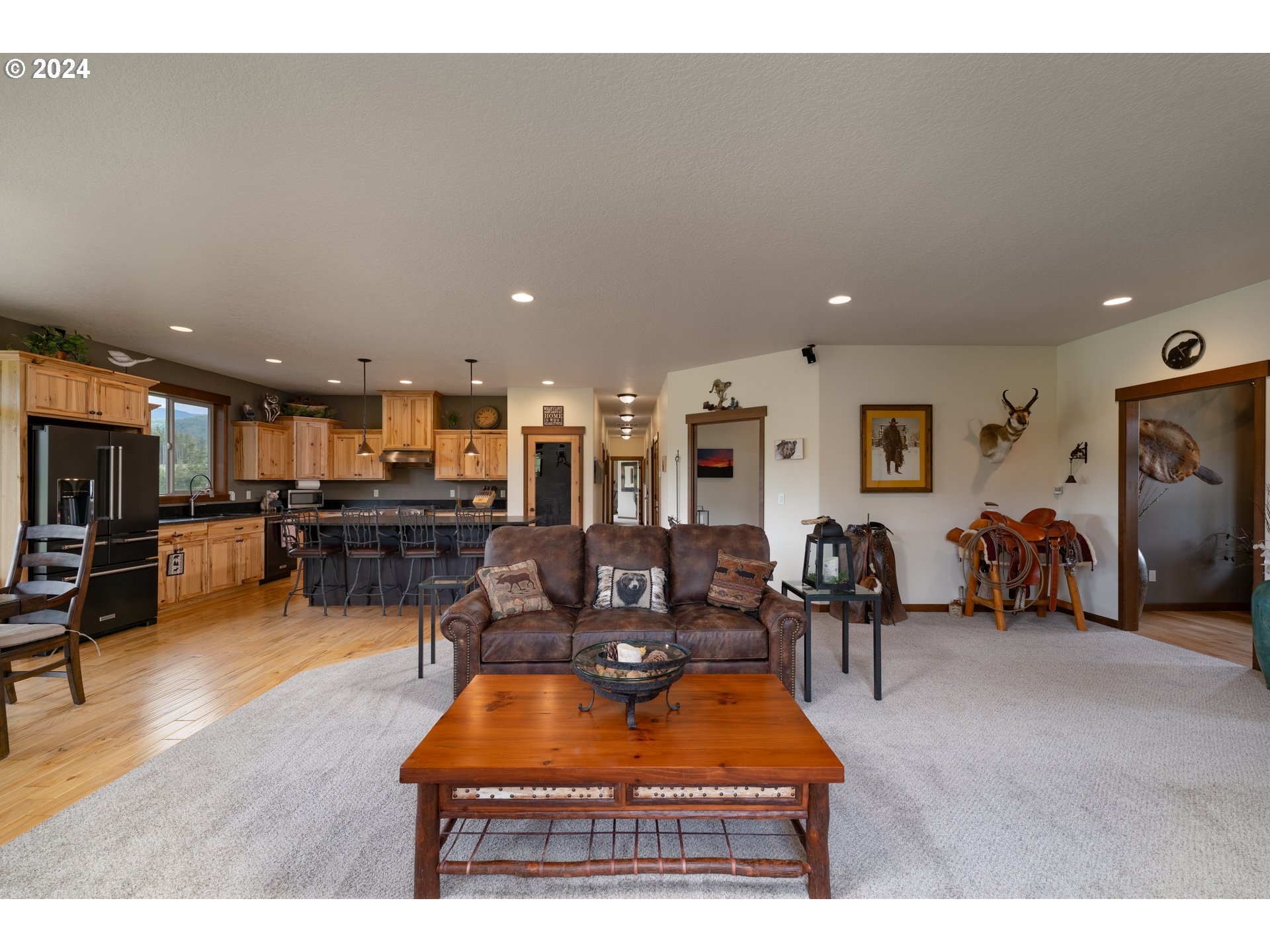 23766 South Bonney Road Colton, OR 97017 - Photo 12 of 32 a living room with furniture a table and kitchen view