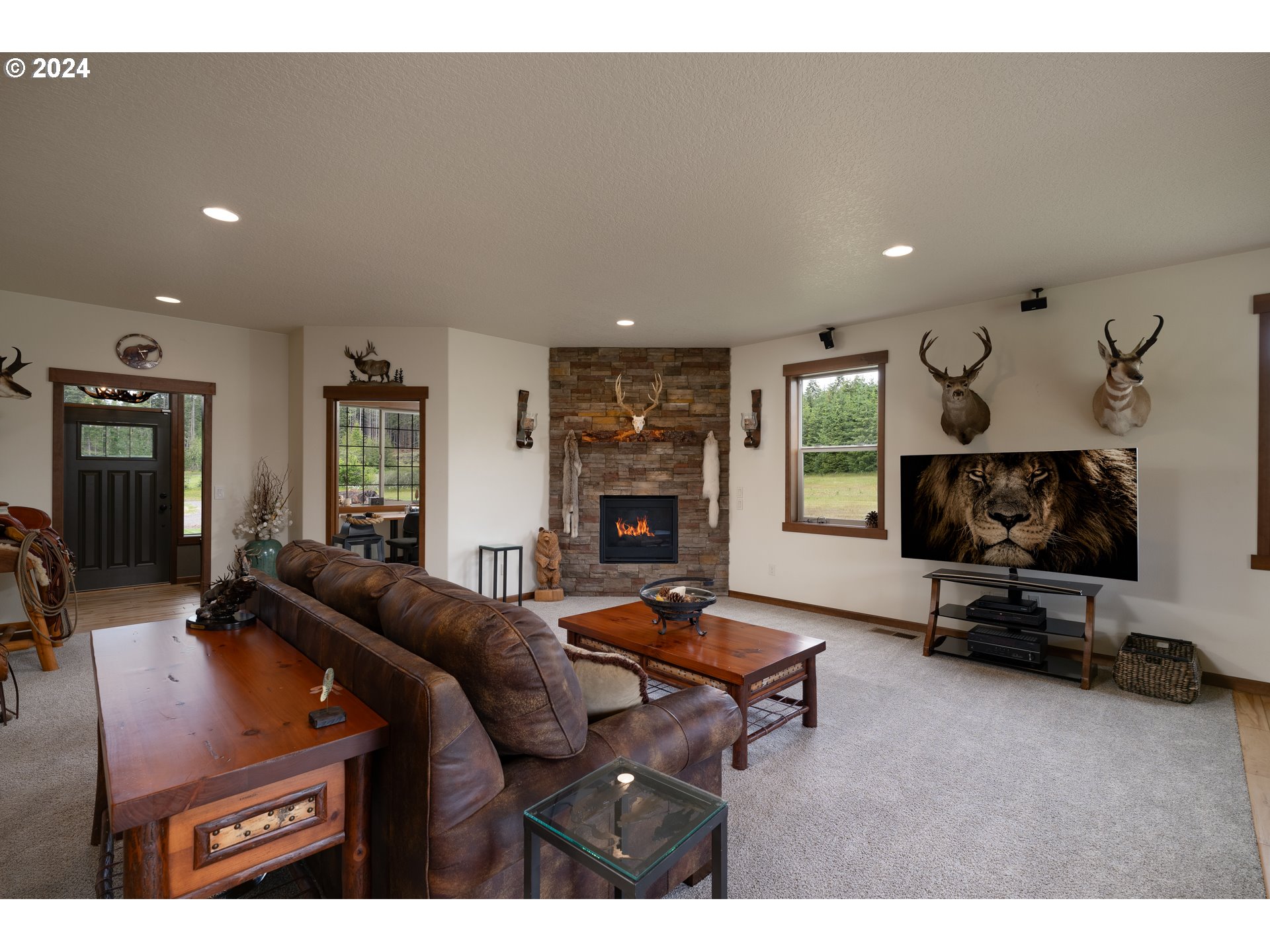 23766 South Bonney Road Colton, OR 97017 - Photo 10 of 32 a living room with furniture a flat screen tv and a fireplace