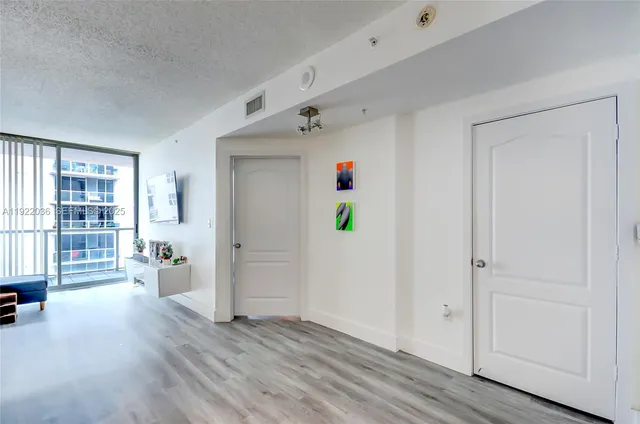 a view of an entryway with wooden floor