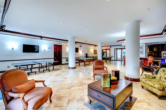 a living room with furniture pool table and large window