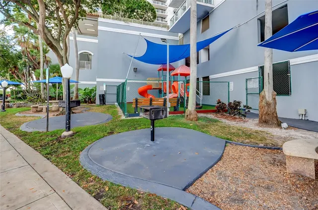 a street view with tall buildings and cars park