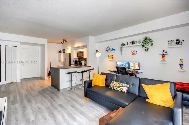 a living room with furniture and kitchen view