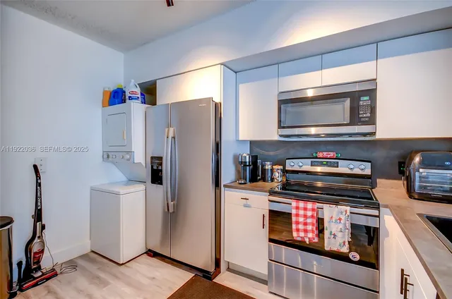 a kitchen with stainless steel appliances a refrigerator a stove and cabinets