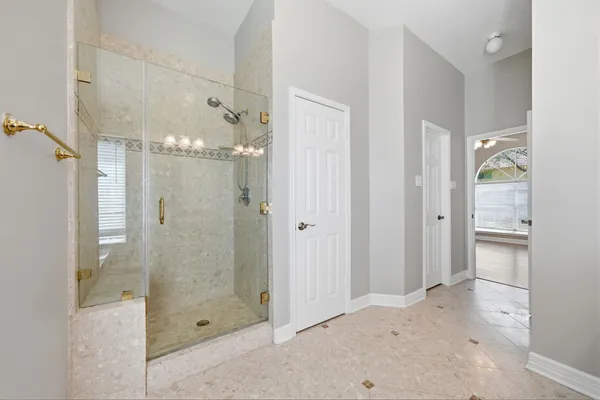 a bathroom with a glass shower door