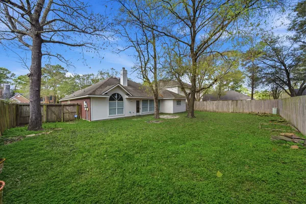 a view of a house with yard and tree s