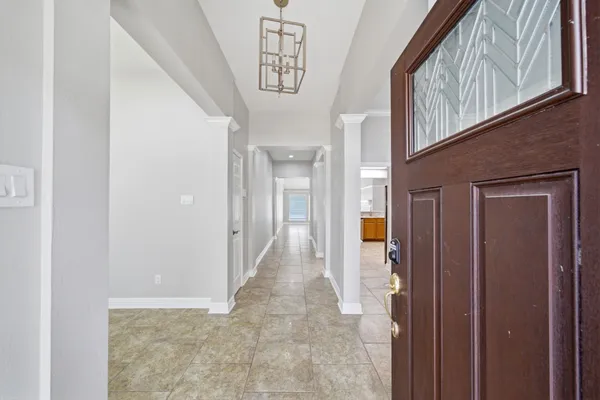 a view of a hallway with wooden shelves